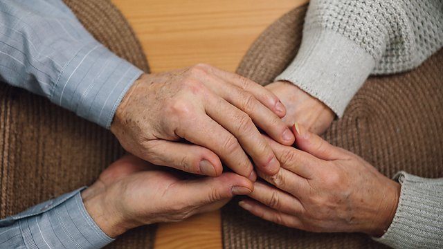 Elderly hands wood table