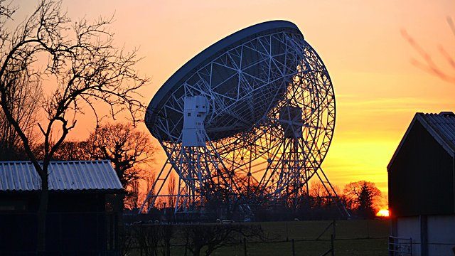 Radio telescope sunset silhouette