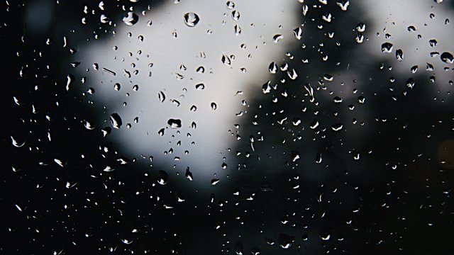 Rain droplets glass dark blurred