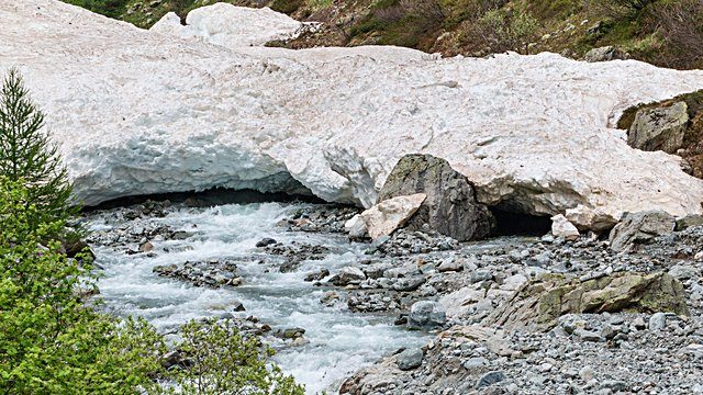 Meltwater stream under snowbank