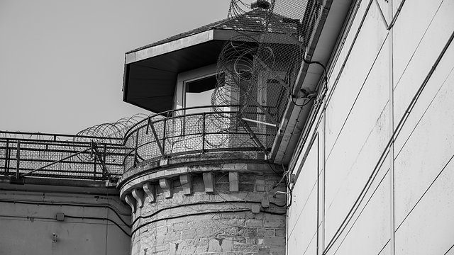 Prison tower razor wire bw