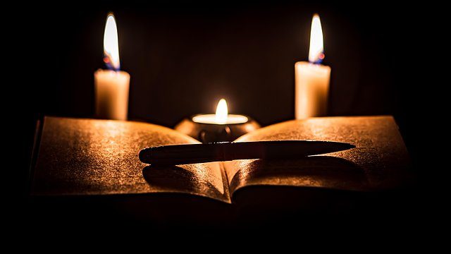 Open book three candles